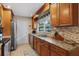 Well-lit kitchen features granite counters, stainless steel appliances, and ample cabinet space at 986 Stonewood Ln, Maitland, FL 32751