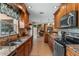 Spacious kitchen with granite countertops, stainless steel appliances, and view to living room fireplace at 986 Stonewood Ln, Maitland, FL 32751