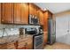 Stainless steel appliances compliment the granite countertops and wooden cabinetry in this kitchen at 986 Stonewood Ln, Maitland, FL 32751