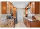 Modern kitchen with granite countertops, stainless steel appliances, and wood cabinets at 986 Stonewood Ln, Maitland, FL 32751