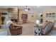 Comfortable living room featuring a brick fireplace and a ceiling fan for a cozy ambiance at 986 Stonewood Ln, Maitland, FL 32751