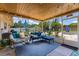 Screened-in patio featuring comfortable seating, string lights, and a view of the backyard, perfect for outdoor relaxation at 986 Stonewood Ln, Maitland, FL 32751