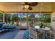 Cozy screened-in patio with outdoor furniture, string lights, and a view of the backyard, perfect for relaxation and entertaining at 986 Stonewood Ln, Maitland, FL 32751
