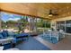 Cozy screened porch with comfortable seating, ceiling fan, and views of the backyard pool and landscaping at 986 Stonewood Ln, Maitland, FL 32751