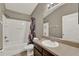 Well-lit bathroom featuring a tub-shower combo, updated fixtures, and neutral decor at 6404 S Goldenrod Rd # A, Orlando, FL 32822