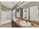 Bathroom showcasing a double sink vanity and glass enclosed shower at 6404 S Goldenrod Rd # A, Orlando, FL 32822