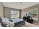 Comfortable bedroom with two windows, neutral walls, and ample natural light at 6404 S Goldenrod Rd # A, Orlando, FL 32822