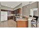 Efficient kitchen with dark wood cabinetry, stainless steel appliances, and breakfast bar at 6404 S Goldenrod Rd # A, Orlando, FL 32822