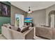 Cozy living room features neutral paint, a ceiling fan, and balcony access at 6404 S Goldenrod Rd # A, Orlando, FL 32822