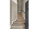 Carpeted stairway leads upstairs with handrail and white painted trim, offering a neutral color palette at 6404 S Goldenrod Rd # A, Orlando, FL 32822