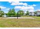 Community volleyball court, a sandy recreation area with lake and fountain views at 6404 S Goldenrod Rd # A, Orlando, FL 32822