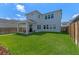 Large backyard with a covered patio, perfect for outdoor entertaining and relaxation at 10183 Peebles St, Orlando, FL 32827