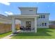 Backyard with patio area, outdoor dining, and well-maintained green lawn at 10183 Peebles St, Orlando, FL 32827