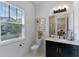 Bright bathroom featuring a modern vanity, stylish mirror, and natural light from the window at 10183 Peebles St, Orlando, FL 32827