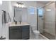 Well-designed bathroom featuring a glass shower, sleek vanity, modern fixtures, and a large mirror at 10183 Peebles St, Orlando, FL 32827