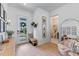 Bright foyer featuring light wood floors, modern decor, stylish seating, and access to a powder room at 10183 Peebles St, Orlando, FL 32827