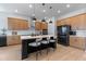 Modern kitchen with a large center island, sleek appliances, and ample cabinet space with trendy bar stools at 10183 Peebles St, Orlando, FL 32827