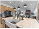 Modern kitchen with large island, farmhouse sink, stainless steel appliances, and seamless flow to the living area at 10183 Peebles St, Orlando, FL 32827