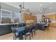 Spacious kitchen and dining area showcasing modern finishes, including stainless steel appliances and a contemporary chandelier at 10183 Peebles St, Orlando, FL 32827