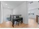 Cozy landing area featuring a piano, hardwood floors, and ample natural light at 10183 Peebles St, Orlando, FL 32827