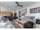 Bright, open-concept living room flows into the kitchen and features comfortable seating, stylish decor, and ample natural light at 10183 Peebles St, Orlando, FL 32827