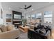 Cozy living room featuring a modern fireplace, comfortable seating, large windows, and stylish decor at 10183 Peebles St, Orlando, FL 32827