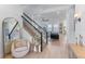 Open concept living space featuring hardwood floors, a staircase and a glimpse of the comfortable living room furniture at 10183 Peebles St, Orlando, FL 32827