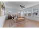 Spacious main bedroom featuring ample natural light, ceiling fan, and a stylish accent rug at 10183 Peebles St, Orlando, FL 32827