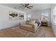 Bright main bedroom with large windows, modern art and a comfortable lounging area on top of stylish rug at 10183 Peebles St, Orlando, FL 32827
