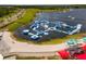 Aerial view of the community water park and lake featuring inflatable slides, climbing walls, and obstacles at 10183 Peebles St, Orlando, FL 32827