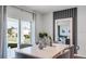 Bright dining area featuring a modern table setting and sliding glass doors at 1080 Clay Blvd, Tavares, FL 32778