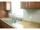A view of the kitchen sink, countertop, and cabinets at 110 N Alderwood St, Winter Springs, FL 32708