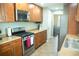 Well-lit kitchen with stainless steel appliances, light countertops, and wooden cabinetry at 110 N Alderwood St, Winter Springs, FL 32708