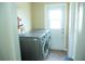 Laundry room with modern washer and dryer units and access to the exterior at 110 N Alderwood St, Winter Springs, FL 32708