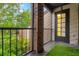 Charming outdoor balcony with black metal railings, brick pillars, and views of lush greenery at 1122 Washington Ave # 7, Winter Park, FL 32789