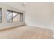Bright bedroom with neutral carpet, a ceiling fan, and a window view of greenery at 1122 Washington Ave # 7, Winter Park, FL 32789