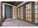 Inviting front porch with brick flooring, elegant French doors, and a stylish entryway, creating a warm welcome at 1122 Washington Ave # 7, Winter Park, FL 32789