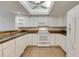 Bright kitchen featuring white appliances, tile flooring, and an illuminated ceiling fan at 1122 Washington Ave # 7, Winter Park, FL 32789