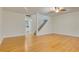 Bright living room featuring hardwood floors and staircase, offering a welcoming and spacious atmosphere at 1122 Washington Ave # 7, Winter Park, FL 32789