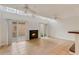 Cozy living space featuring skylights, a fireplace, sliding doors, and tiled flooring at 1122 Washington Ave # 7, Winter Park, FL 32789