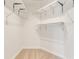 Spacious walk-in closet featuring ample white shelving and neutral carpeting for optimal storage and organization at 1122 Washington Ave # 7, Winter Park, FL 32789