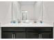 Elegant bathroom with dual sinks, sleek countertops, and a large mirror, providing a spa-like feel at 1128 Challenge Dr, Davenport, FL 33896