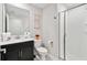 Modern bathroom featuring a sleek vanity, a toilet and a glass-enclosed shower, with clean lines and neutral tones at 1128 Challenge Dr, Davenport, FL 33896