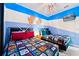 Themed bedroom featuring twin beds, Star Wars decor, and colorful bedding, creating a fun space at 1128 Challenge Dr, Davenport, FL 33896