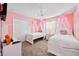 Charming bedroom with two twin beds, decorative canopies, and a playful pink color scheme at 1128 Challenge Dr, Davenport, FL 33896