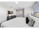 Serene bedroom with soft light, featuring a plush bed, modern decor, and a large window at 1128 Challenge Dr, Davenport, FL 33896