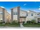 Modern two-story home with stone accents, manicured landscaping, and a vibrant red front door at 1128 Challenge Dr, Davenport, FL 33896