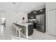 Modern kitchen featuring a large island with bar seating, stainless steel appliances, and ample cabinet space at 1128 Challenge Dr, Davenport, FL 33896