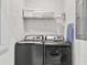 Modern laundry room with side by side washer and dryer and linen closet at 1128 Challenge Dr, Davenport, FL 33896