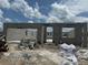 The shell of the house is under construction with a clear blue sky and clouds in the background at 1153 Basalt Ln, Sanford, FL 32771